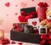 Romantic Valentine gift hamper featuring a teddy bear, chocolates, scented candle, greeting card, roses, and premium gift boxes arranged in an elegant presentation for online gifting in Pakistan.